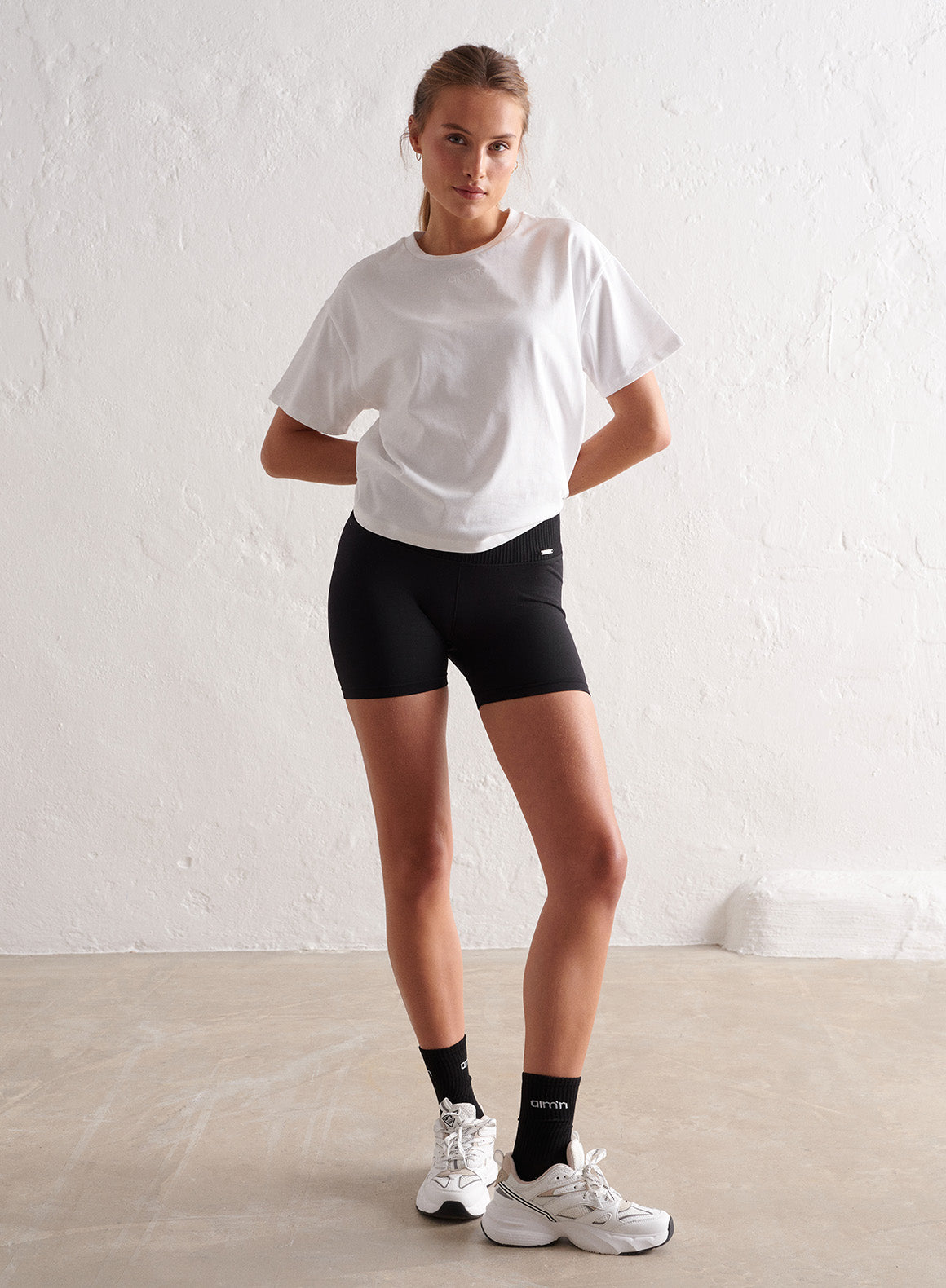 Co Activewear - BLACK LIMITLESS SEAMLESS MIDI BIKER SHORTS fifth image
